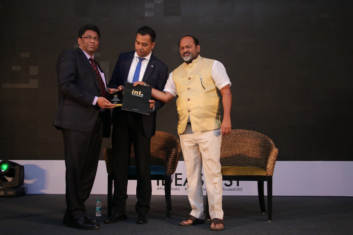 Award recipient with trophy at The Cover Story World Magazine awards