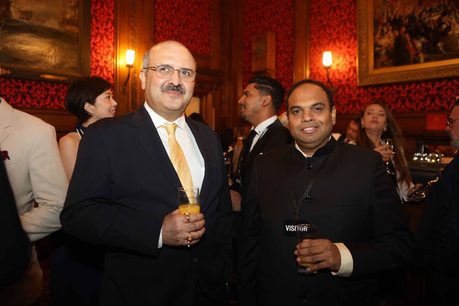 Two guests photographed together at the evening reception
