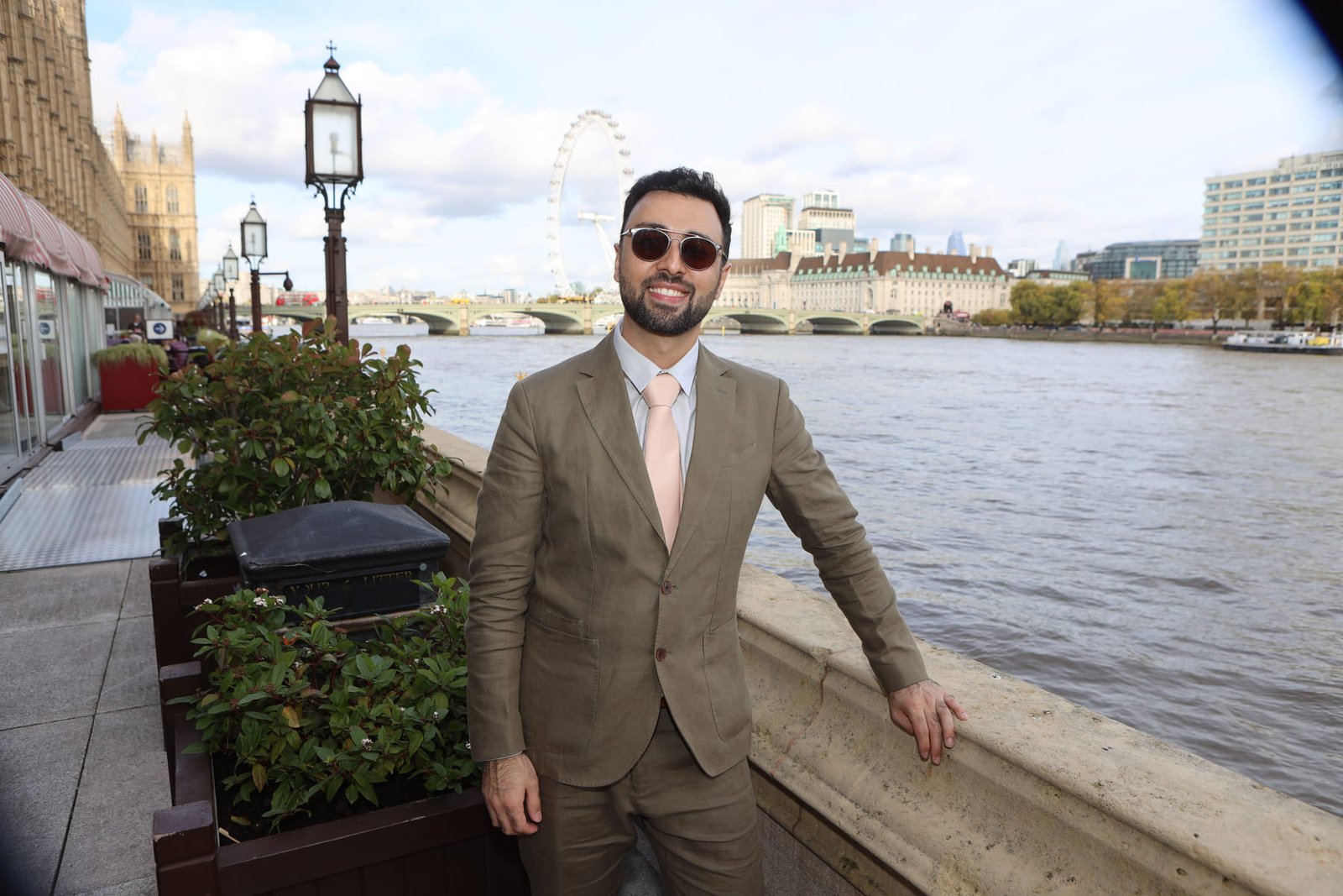 A leader photographed on the terrace at Westminster, the London Eye behind